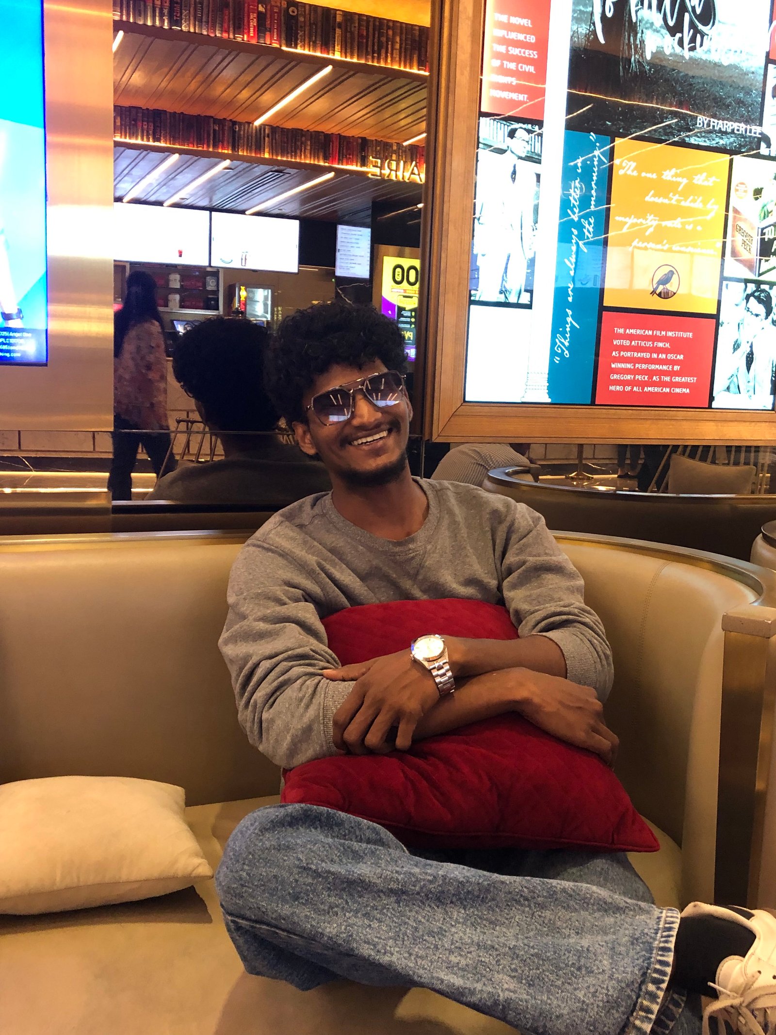 Omi smiling on a couch